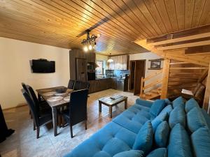 a living room with a blue couch and a table at Przystanek Beskidy in Brenna