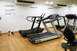 a gym with three exercise bikes in a room at Gdańsk Szafarnia Waterlane SPA by Jacek Budek in Gdańsk