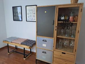 a wooden cabinet with a bench next to a shelf at El Sitio de mi Recreo in Trevélez