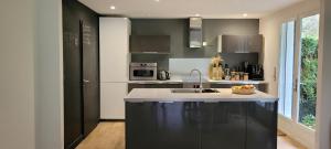 a kitchen with a sink and a counter top at Villa 4ch jardin proche de Lille in Bondues