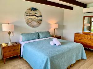 a bedroom with a blue bed and two lamps at Vista Grande Resort - A Gay Men's Resort in Palm Springs