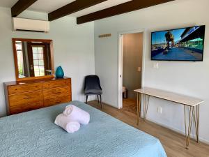 a bedroom with a bed with a television on the wall at Vista Grande Resort - A Gay Men's Resort in Palm Springs