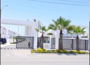 un grupo de palmeras frente a un edificio en Ecusuites Playas House III Resort Altamar 45Min GYE en Playas