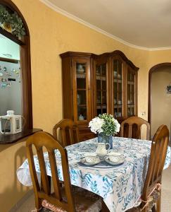 a dining room table with a blue and white table cloth at Demetra Apartment Sperlonga in Sperlonga