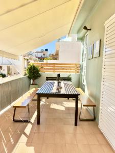 a balcony with a table and benches on it at Luxury Apt 115m2 in Athens