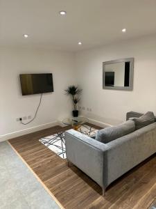 a living room with a couch and a flat screen tv at Hoxton Street, Shoreditch in London