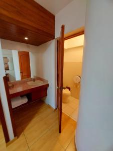 a bathroom with a sink and a toilet at Epiqus Hotel in Lima +65 photos
