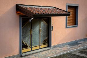 una entrada a un edificio con una puerta de cristal en RESIDENZA IL ROCCOLO en San Fermo della Battaglia