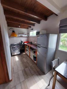 a kitchen with a stainless steel refrigerator and a table at Esquel Loft in Esquel
