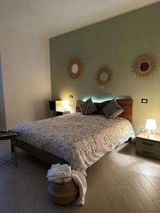 a bedroom with a bed and two mirrors on the wall at B&B Le Chicche di Lulu' in Borghetto