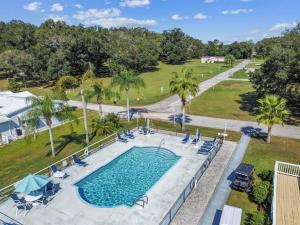 an overhead view of a pool with chairs and trees at 2 Bed Cozy Home, Dade City, Pickle Ball and Pool in Dade City