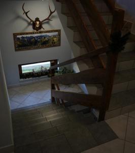 a staircase in a house with a deer head on the wall at Pokoje Gościnne Bartuś in Czarna Góra