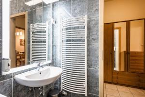 un baño con lavabo y espejo en Downtown charm with balcony and garden view, en Budapest 14 fotos más