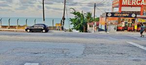 a car parked on the side of a street near the ocean at Natal Plaza in Natal +12 photos
