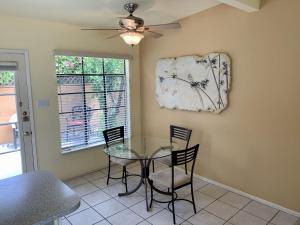 a dining room with a glass table and chairs at Vista Grande Resort - A Gay Men's Resort in Palm Springs