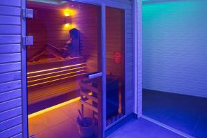 a walk in shower with purple lights in a room at Mangio Fango Hotel et Spa in Saintes-Maries-de-la-Mer