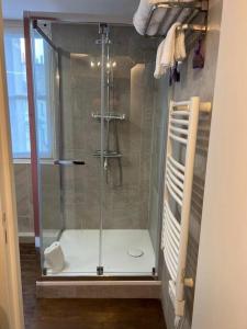 a shower with a glass door in a bathroom at L'esKale / Gare de Tours in Tours