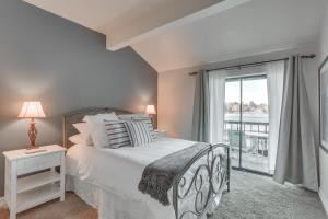 a bedroom with a bed and a large window at Waterfront Lake Arrowhead Townhome with Balconies! in Lake Arrowhead