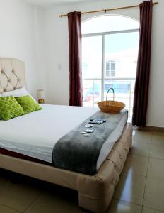 a bedroom with a bed with a large window at Ecusuites Playas House VI Resort Altamarll Piscina Playa in Playas +34 photos