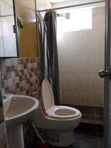 a bathroom with a toilet and a sink at El Amanecer 2.0 in Abancay