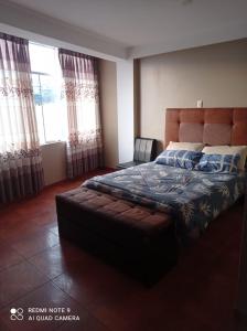 1 dormitorio con 1 cama grande y 1 sofá en El Amanecer 2.0, en Abancay