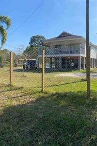 a fence in front of a house at Rancho Alegre. Bring your boat and RV too! in Clewiston