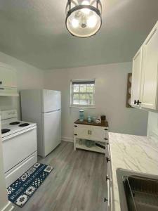 a kitchen with a stove and a white refrigerator at Rancho Alegre. Bring your boat and RV too! in Clewiston