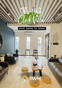a living room with couches and a table at Ipoh 19A Villa for 12pax 6 Carpark with BBQ by IWH in Ipoh