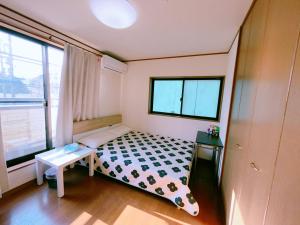 a small bedroom with a bed and a window at 美山小屋-临近东京夏日乐园，高尾山，相模湖游乐园 in Hachioji