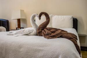 two swans are sitting on top of a bed at Casa Rosen Ocean View Villa in Nacascolo