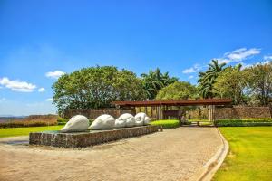 a park with a bench with a group of sculptures at Casa Rosen Ocean View Villa in Nacascolo