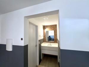 a bathroom with a sink and a mirror at Pousada Ilha do Campeche in Florianópolis
