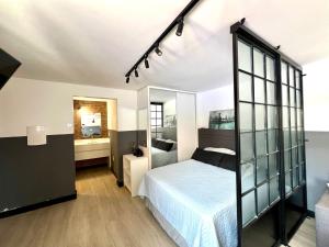 a bedroom with a bed and a mirror at Pousada Ilha do Campeche in Florianópolis