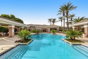 a swimming pool at a resort with palm trees at Kierland Greens #2122 in Scottsdale