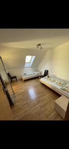 a large room with two beds and a window at MT-Rooms in Kapfenberg