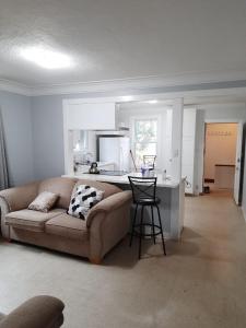 a living room with a couch and a kitchen at House -1 in Thunder Bay