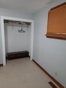 an empty room with a bed and a window at House -1 in Thunder Bay