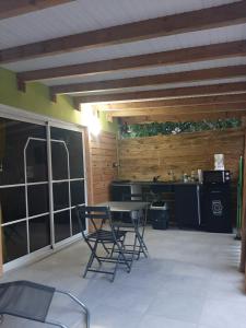 a patio with chairs and a table and a kitchen at Zaboka delair in Sainte-Anne