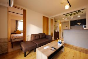 a living room with a couch and a table at Nakajima Park stay AMS tower Nakajima 16F in Sapporo