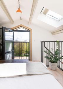 a bedroom with a bed and a balcony at The Studio at The Grain Store in Falmer