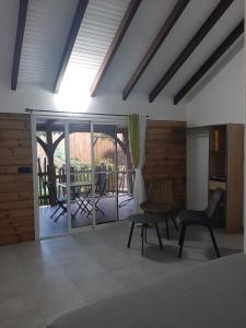 a room with two chairs and a sliding glass door at Zaboka delair in Sainte-Anne