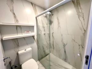 a bathroom with a shower and a toilet at Pousada Ilha do Campeche in Florianópolis