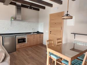 a kitchen with a table and a dining room at Apartamentos Casa Reconco in Luanco