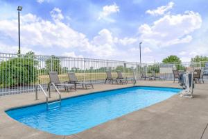 a swimming pool with lounge chairs and ahaps at Holiday Inn Express - Rensselaer, an IHG Hotel in Rensselaer