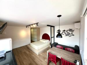 a bedroom with a bed and a table and chairs at Pousada Ilha do Campeche in Florianópolis