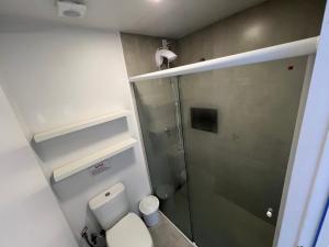 a small bathroom with a toilet and a shower at Pousada Ilha do Campeche in Florianópolis