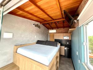 a bed in a small room with a television at Pousada Ilha do Campeche in Florianópolis