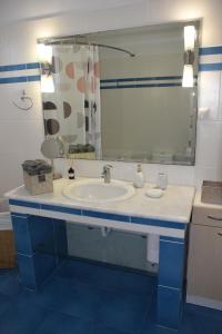 a bathroom with a sink and a mirror at VILLAGE HOUSE in Tríkala +15 photos