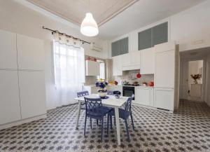 a kitchen with a table and chairs in a room at Le Bijou Luxury Apartment in Salerno