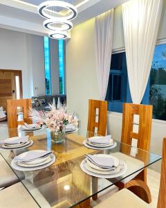 a dining room with a glass table and chairs at 5 Star Villa minutes from Airport and Beaches in Sosúa